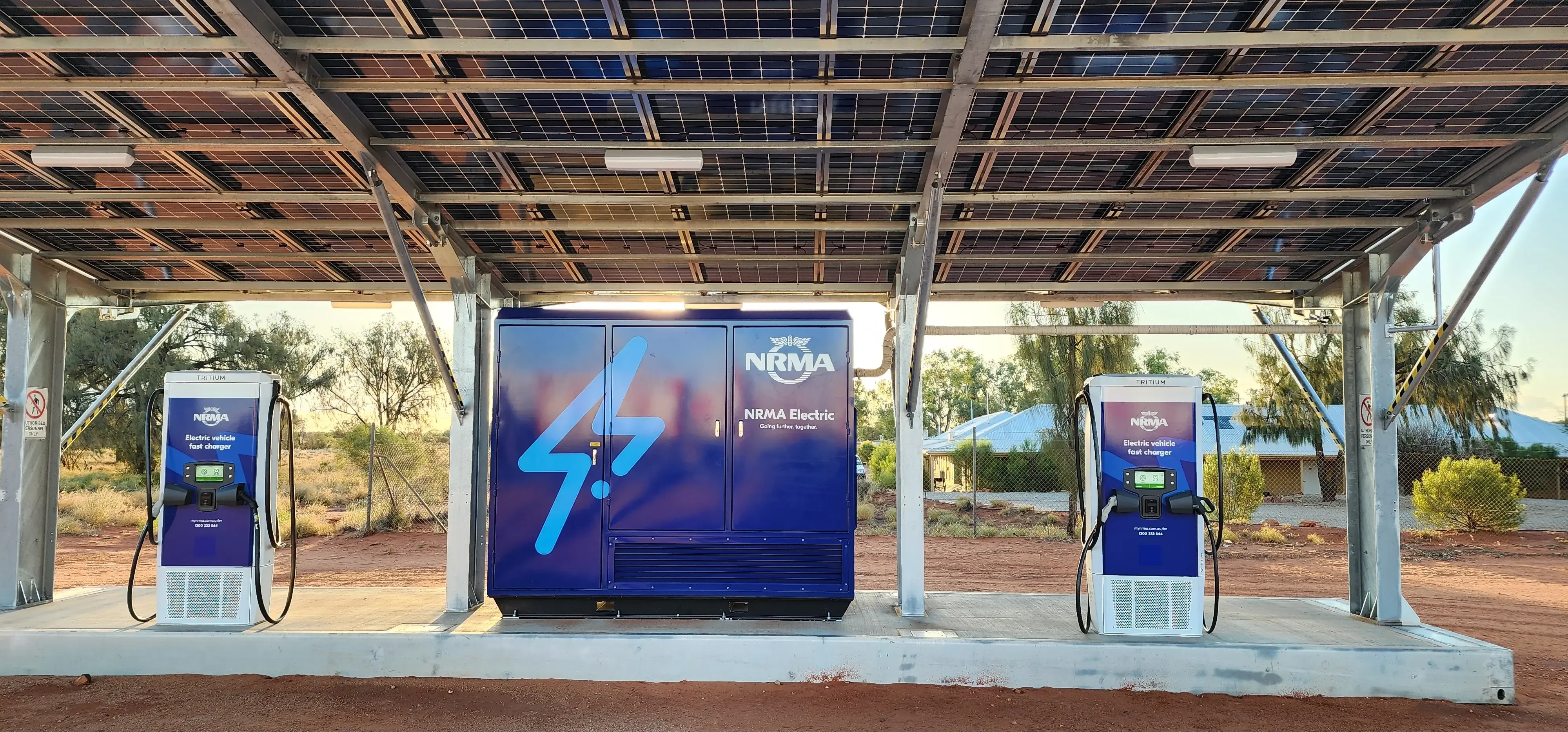 Electric vehicle fast chargers under a solar-panelled carport