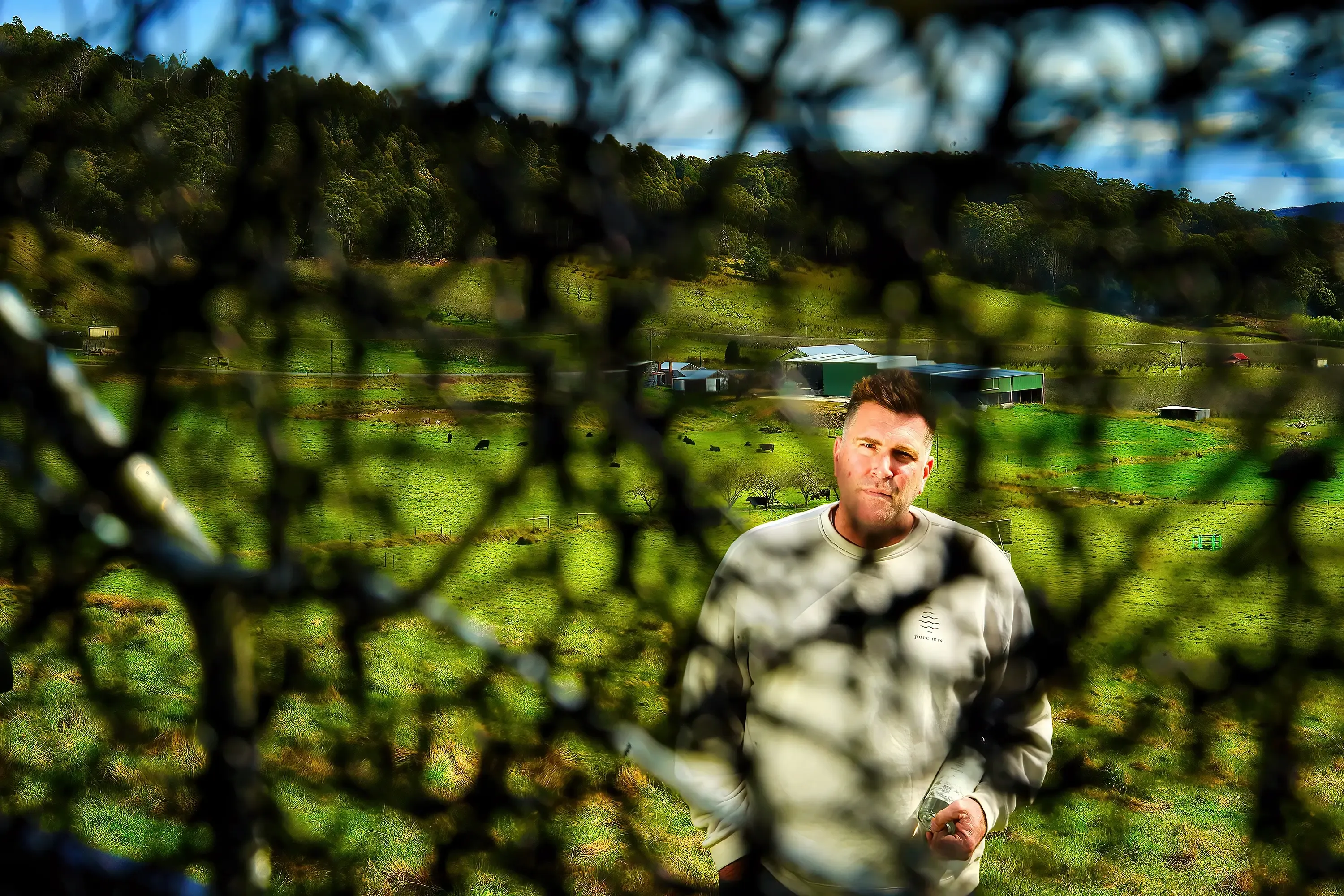 A Pure Mist representative pictured through timber yards above the farm