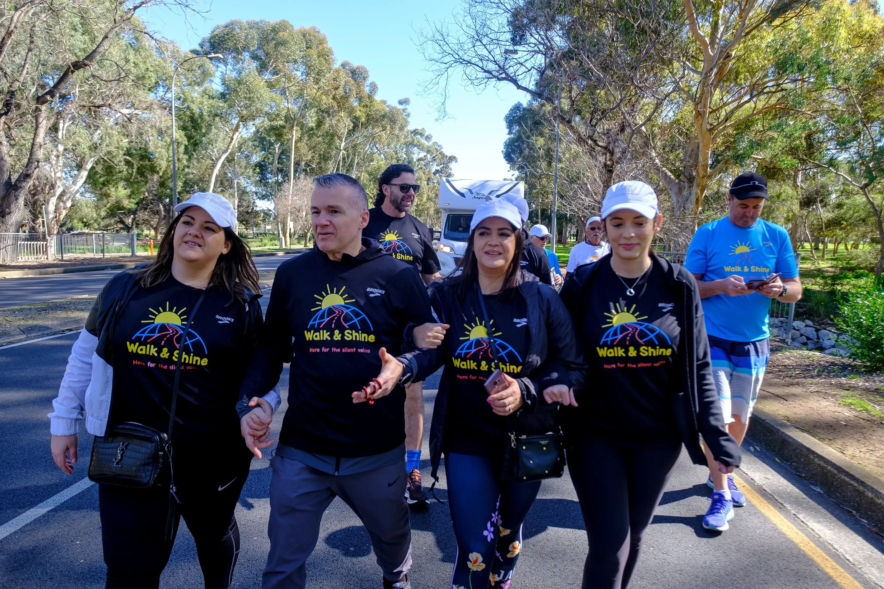 Walk and Shine participants crossing a road during the walk
